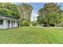 View of the front lawn with trees and greenery surrounding the property at 4384 Raven Valley Ct, Decatur, GA 30035
