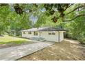 Charming painted brick home with a well-maintained lawn and mature trees at 5729 Jefferson Ave, Forest Park, GA 30297