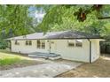 Charming painted brick home with a well-maintained lawn and mature trees at 5729 Jefferson Ave, Forest Park, GA 30297