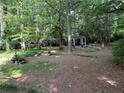 Private backyard with a gazebo, a water fountain and mature trees perfect for relaxation and outdoor entertainment at 125 Fortuna Ct, Roswell, GA 30075