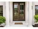 Elegant double doors with glass panes and sidelights, framed by white columns at 2211 Lattimore Farm Nw Dr, Kennesaw, GA 30152