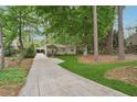 Quaint home with long driveway, mature trees, and inviting curb appeal at 2586 Valley Stream Dr, Atlanta, GA 30360