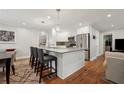 Modern kitchen with an island, stainless steel appliances, and hardwood floors at 2586 Valley Stream Dr, Atlanta, GA 30360