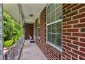 Cozy covered front porch with brick siding and white railing at 261 Demetra Se Dr, Mableton, GA 30126
