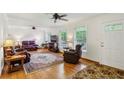 Bright living room with hardwood floors, ceiling fans, and comfortable leather furniture at 261 Demetra Se Dr, Mableton, GA 30126