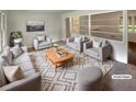 Virtually staged living room featuring gray furniture, geometric rug, and lots of natural light at 4246 Chestnut Grove Ln, Austell, GA 30106