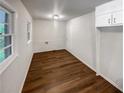 Room with hardwood floors, freshly painted walls, and a rear entry/exit door at 4246 Chestnut Grove Ln, Austell, GA 30106