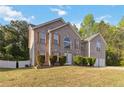 Traditional home with brick facade, shuttered windows, and a well-kept lawn surrounded by mature trees at 6252 Selborn Sw Dr, Atlanta, GA 30331