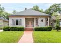 Inviting home exterior with a brick walkway, lush lawn, and charming curb appeal at 668 Peeples Sw St, Atlanta, GA 30310