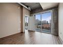 Bright bedroom boasts hardwood floors, modern lighting, and city views at 943 Peachtree Ne St # 1010, Atlanta, GA 30309