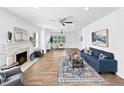 Bright living room features a fireplace, hardwood floors, ceiling fan, and an open floor plan at 2896 Toney Dr, Decatur, GA 30032
