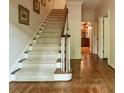Elegant staircase with carpeted steps and hardwood flooring, leading to the upper level of this beautiful home at 335 Cameron Ridge Dr, Atlanta, GA 30328