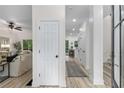 Bright entryway with white walls, wood floors, and a view into the living room and dining area at 5560 Pilgrim Point Ext, Cumming, GA 30041
