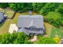 Aerial shot of home showcasing the roof, driveway, walkway, and lush green landscaping at 5960 Bridge Stone Ct, Cumming, GA 30028