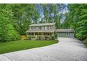 Beautiful two-story home with a well-manicured lawn and an ample driveway nestled in a lush, green environment at 220 Hillswick Ct, Atlanta, GA 30328