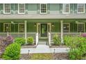 Inviting front porch with ceiling fans and classic black rocking chairs, perfect for relaxing outdoors at 220 Hillswick Ct, Atlanta, GA 30328