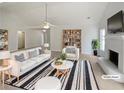 Bright living room featuring neutral walls, fireplace, and stylish furniture at 30 Trelawney Ct, Covington, GA 30016