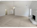 Spacious living room featuring neutral walls, fireplace, and a vaulted ceiling at 30 Trelawney Ct, Covington, GA 30016
