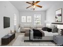 Spacious staged bedroom with neutral carpet, lots of natural light, and modern decor at 3037 Bonnes Dr, Lithonia, GA 30038