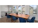 Bright dining room with a wooden table, plush blue chairs, and abundant natural light at 3982 Carver Cir, Doraville, GA 30360