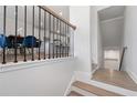 Modern staircase with wood treads, iron railings, and neutral walls leading to the dining room and kitchen at 3982 Carver Cir, Doraville, GA 30360