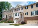 Inviting townhome row with neat landscaping, brick accents, and individual garage entrances at 4306 Laurel Creek Se Ct, Smyrna, GA 30080