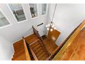 Elegant foyer showcasing hardwood floors, a staircase with iron spindles, and a stylish chandelier at 4649 Equestrian Way, Atlanta, GA 30338