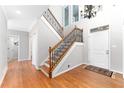 Bright entryway with hardwood floors, stairs with iron spindles, and a soaring ceiling at 4649 Equestrian Way, Atlanta, GA 30338