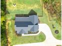Aerial view of a well-maintained home, lush landscaping, long driveway and fenced-in backyard at 62 Presley Farm Pkwy, Rockmart, GA 30153