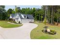 Beautiful white home with a long driveway, lush lawn, and fenced backyard at 62 Presley Farm Pkwy, Rockmart, GA 30153