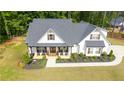 Charming home with a manicured front yard, rocking-chair porch, and a blend of modern farmhouse charm at 62 Presley Farm Pkwy, Rockmart, GA 30153