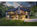 Two-story home with a large deck, backyard, finished basement, and surrounded by lush greenery and trees at 2334 Fisher Dr, Loganville, GA 30052