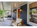 Relaxing front porch with seating, wood door, charming exterior lighting, and serene neighborhood views at 2647 Forrest Nw Ave, Atlanta, GA 30318