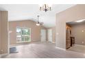 Open floor plan living room with fireplace, ceiling fan, stainless appliances, and dining area at 5805 Eagles Feather Ln, Riverdale, GA 30274