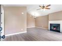 Spacious living room with high ceilings, fireplace, ceiling fan, and lots of natural light at 5805 Eagles Feather Ln, Riverdale, GA 30274