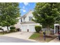 Inviting two-story home featuring a two-car garage, well-kept lawn, and mature trees for added curb appeal at 720 Mountain Laurel Dr, Canton, GA 30114