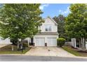 Charming two-story home with a two-car garage, well-manicured lawn, and mature trees at 720 Mountain Laurel Dr, Canton, GA 30114