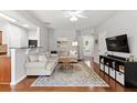 Comfortable living room with a plush sectional, hardwood floors, and a cozy atmosphere at 720 Mountain Laurel Dr, Canton, GA 30114
