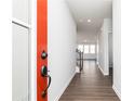 Inviting hallway features hardwood floors, neutral paint and trim, with a view into the sun filled living room at 116 Chattahoochee Cir, Locust Grove, GA 30248