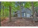 Charming two-story home showcasing a side-entry garage surrounded by mature trees and natural landscaping at 3067 Nuptial Ln, Lawrenceville, GA 30044