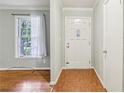 Bright entryway with a window to the left and coat closet to the right featuring patterned tile flooring at 4074 Idlevale Dr, Tucker, GA 30084