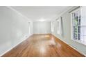 Spacious living room featuring freshly painted walls, hardwood floors and plenty of natural light from the windows at 4074 Idlevale Dr, Tucker, GA 30084