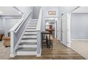 Bright foyer showcasing a staircase and hardwood flooring leading to the upper level at 6297 Polar Fox Ct, Riverdale, GA 30296