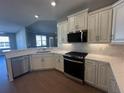 Modern kitchen showcasing stainless steel appliances, quartz countertops, and wood flooring at 1001 Calypso Way # 1001, Cumming, GA 30040