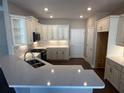 Bright kitchen featuring stainless steel appliances, quartz countertops, and white cabinets at 1001 Calypso Way # 1001, Cumming, GA 30040