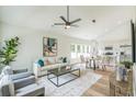 Bright, open-concept living area with modern furnishings flowing into dining and kitchen at 2621 Oldknow Nw Dr, Atlanta, GA 30318