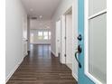 Inviting entryway with wood flooring, light gray walls, and a view of the open-concept living space at 509 Altamaha Ct, Locust Grove, GA 30248