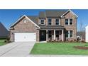 Beautiful two-story brick home with a two-car garage, covered porch, and well-maintained landscaping at 509 Altamaha Ct, Locust Grove, GA 30248