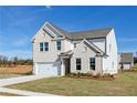 Beautiful two-story home showcasing a well-kept lawn and brick exterior details at 736 Ocmulgee Xing, Locust Grove, GA 30248
