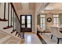 Bright foyer with hardwood floors, staircase, and dining room, creating an elegant and open entrance at 1830 Hadfield Blvd, Roswell, GA 30075